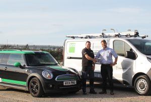 Bott and Lightfoot employees shaking hands in front of their respective companies' vans